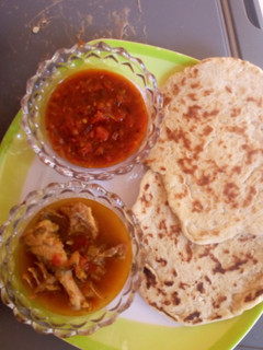 A picture of NAAN bread with souce and pepper soup.