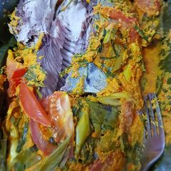A picture of PEPES IKAN WOKU IN HERBAL CURRY, WRAP WITH BANANA LEAVES.
