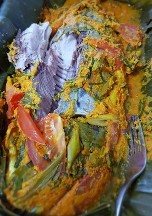 A picture of PEPES IKAN WOKU IN HERBAL CURRY, WRAP WITH BANANA LEAVES.