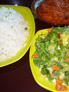 A picture of White rice and stew with salad.