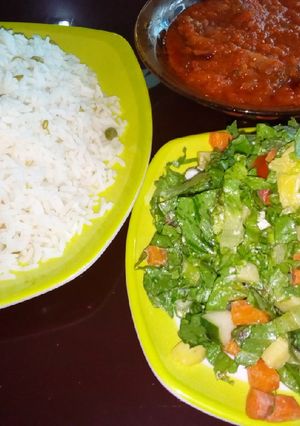 A picture of White rice and stew with salad.