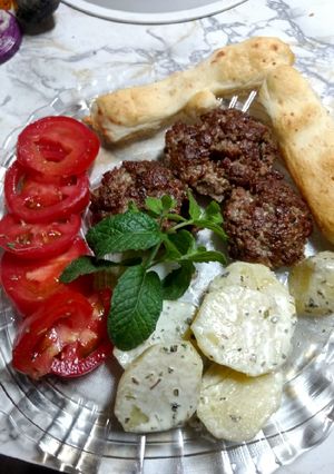 Una foto de Hamburguesas con semillas y papas a la crema, tomate con jengibre