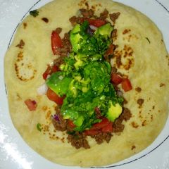 A picture of Beef tacos using homemade tortillas.