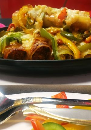 A picture of Italian lasagna cannelloni filled with Indian paner tikka.