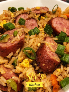 A picture of Fried rice with andouille sausage In Wok.