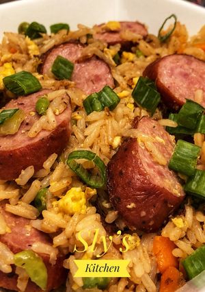 A picture of Fried rice with andouille sausage In Wok.