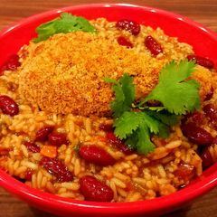 A picture of Mike's Crispy Cajun Legs Over Red Beans & Rice.