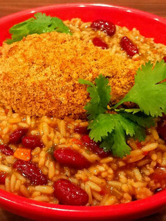 A picture of Mike's Crispy Cajun Legs Over Red Beans & Rice.