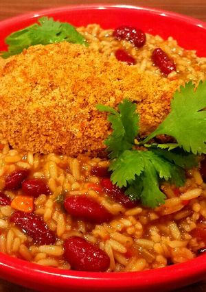 A picture of Mike's Crispy Cajun Legs Over Red Beans & Rice.