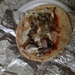 A picture of Chicken parm on pita wrap.