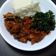 Ugali served with boiled mutton and spinach A picture of Ugali served with boiled mutton and spinach.