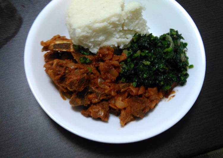 Ugali served with boiled mutton and spinach