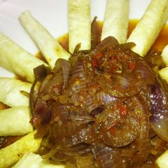 A picture of Yam fries with onion sauce.