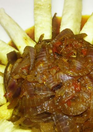 A picture of Yam fries with onion sauce.