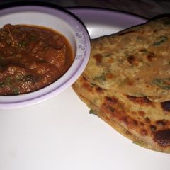 A picture of Kraara methi paratha with tomato chutney.