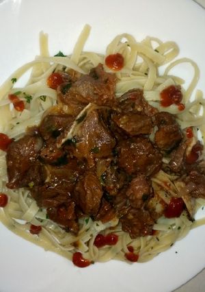 A picture of Beef stew and pasta Linguine.