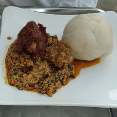 A picture of Egusi soup with pounded yam.