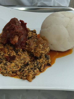 A picture of Egusi soup with pounded yam.