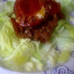 A picture of Pizza casserole on a bed of lettuce.