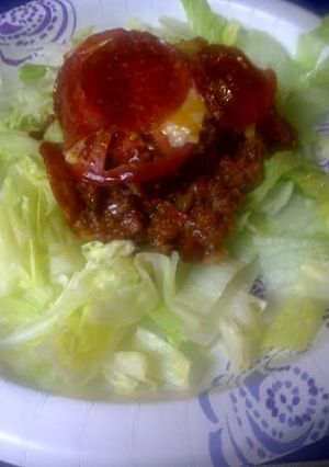 A picture of Pizza casserole on a bed of lettuce.
