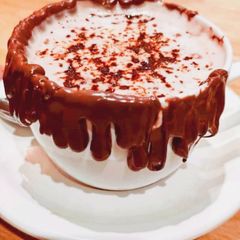 A picture of Cappuccino with chocolate syrup.
