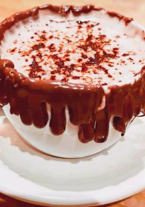A picture of Cappuccino with chocolate syrup.
