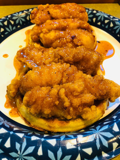 A picture of Chicken 🐔 and Waffles 🧇with a Spicy 🥵Maple Sauce.