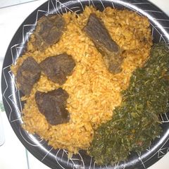 A picture of Jollof rice,fried beef and vegetable.