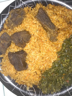 A picture of Jollof rice,fried beef and vegetable.
