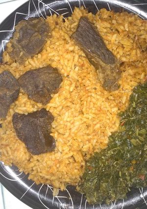 A picture of Jollof rice,fried beef and vegetable.