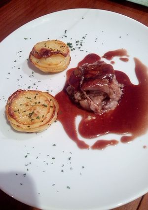 Una foto de Manitas de Cerdo Rellenas de Boletus, Milhojas de Patatas y Salsa de Oporto