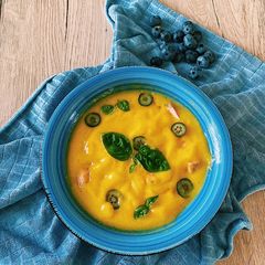 A picture of Mango soup with salmon, blueberries and basil💛.