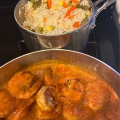 A picture of Shrimp in tomato salsa and white rice.