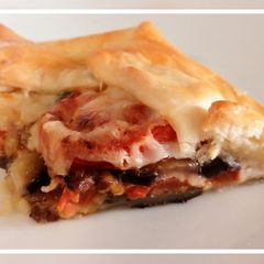 A picture of Torta salata di melanzane, pomodori e caciocavallo.