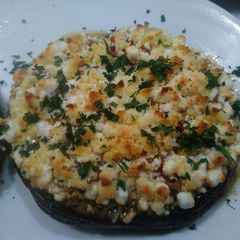 A picture of Stuffed Portobello Mushrooms With oven roasted tomatoes.