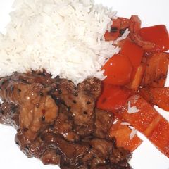 A picture of Sesame beef with 5 spice peppers and rice.