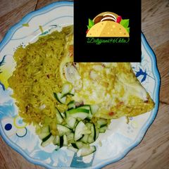 A picture of Jallof rice with omelette and cucumber.