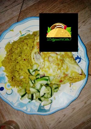A picture of Jallof rice with omelette and cucumber.