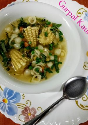 A picture of Corn, macaroni soup 🍲🍅🧅🥕.