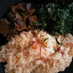 A picture of Fried rice with greens and meat.