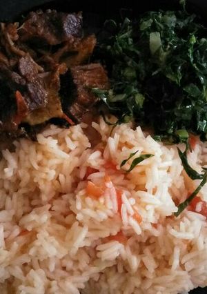 A picture of Fried rice with greens and meat.