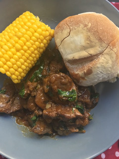 A picture of Peri-Peri chicken livers with sweetcorn and Portuguese rolls.