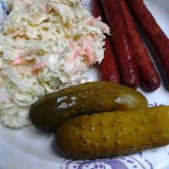 A picture of My ultimate coleslaw with deep fried hotdogs.