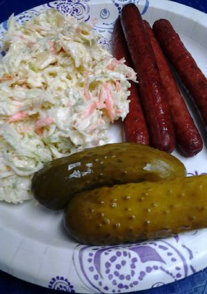 A picture of My ultimate coleslaw with deep fried hotdogs.
