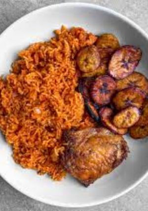 A picture of Jollof rice with fried chicken and plantain.