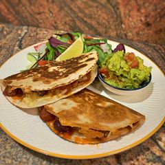 A picture of Smoky QuesadillasChicken & chorizo /Jackfruit & veggie sausages.