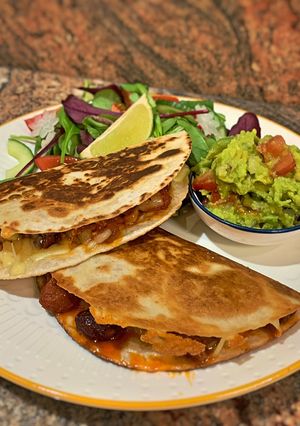 A picture of Smoky QuesadillasChicken & chorizo /Jackfruit & veggie sausages.