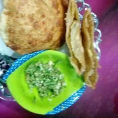 A picture of Moong Daal kachori with green chilli garlic chutney.