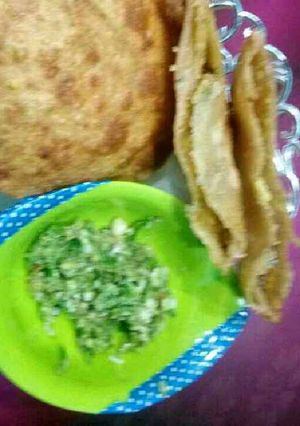 A picture of Moong Daal kachori with green chilli garlic chutney.