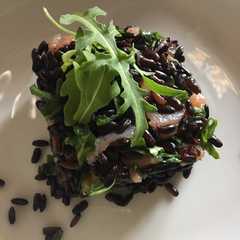 A picture of Venere (Black) Rice with Arugula and Salmon.